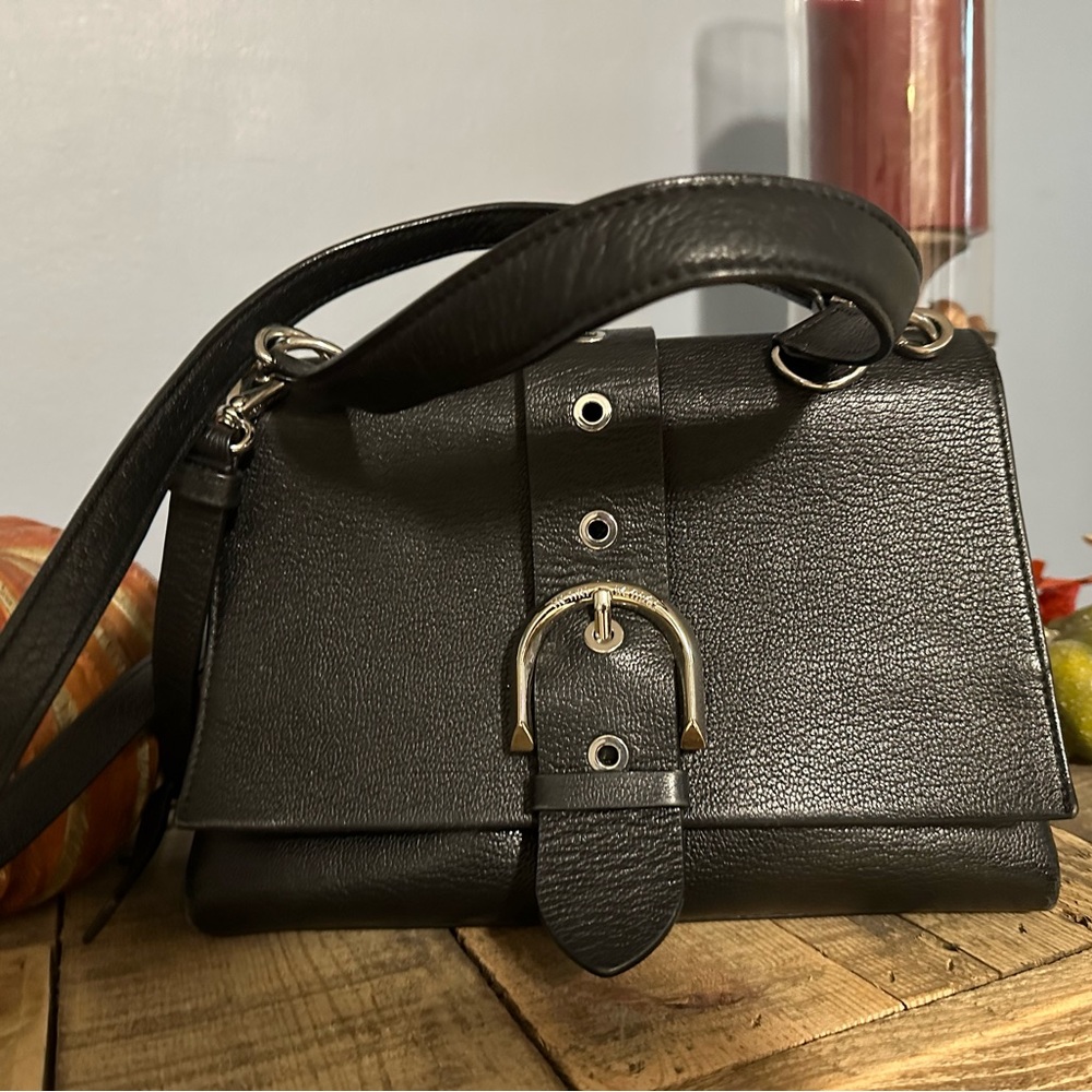Black shoulder bag with silver buckle latch. Excellent condition. Collectors bag